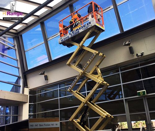 window-cleaning-in-ivanhoe-grammar-school-Melbourne-using-a-scissor-lift-in-order-to-reach-those-hard-to-access-windows