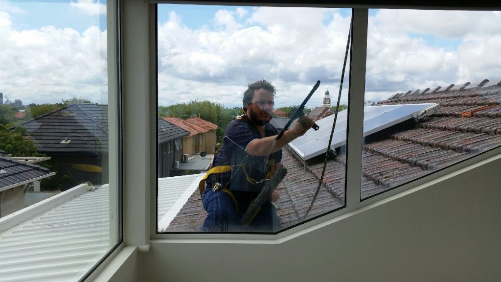 hirange-window-cleaner-using-a-squeegee