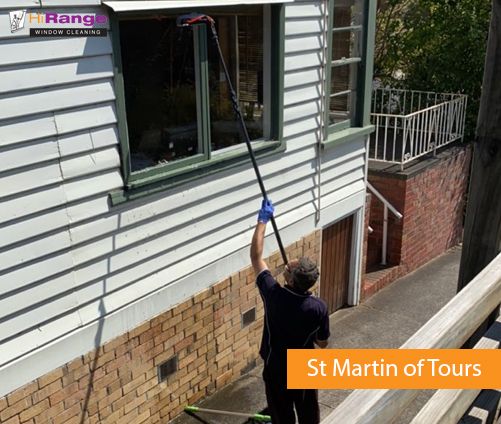 hirange window cleaner is cleaning the exterior windows of st martin of tours in Rosanna